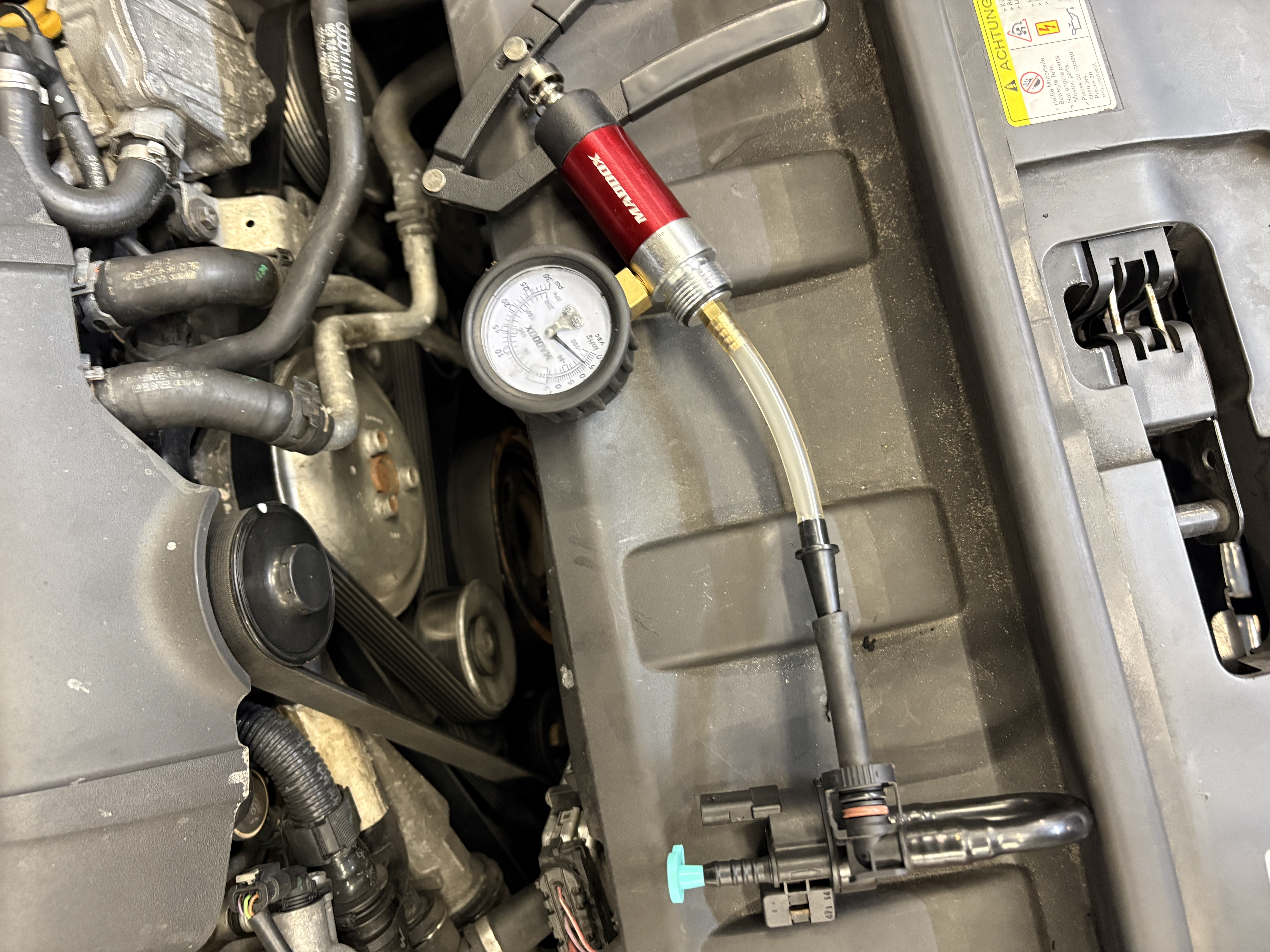 Compression test gauge on Mercedes engine